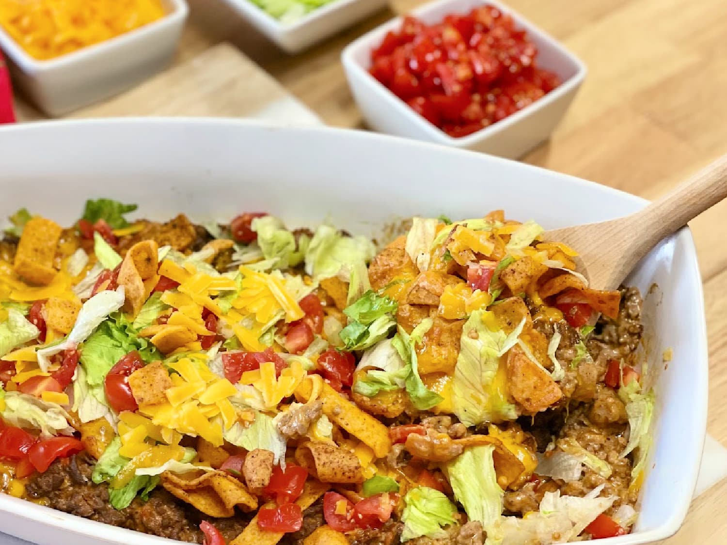 A pan of Walking Taco Casserole with all the toppings. 