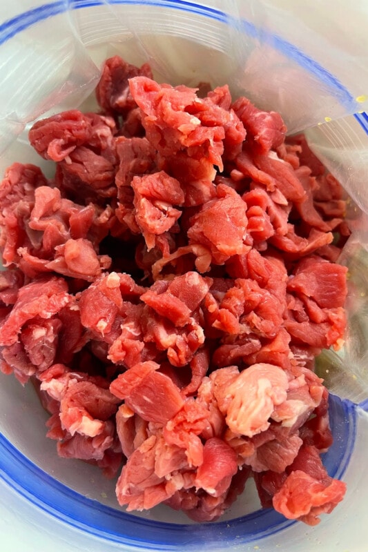 Meat placed on top of the marinade in a gallon bag. 