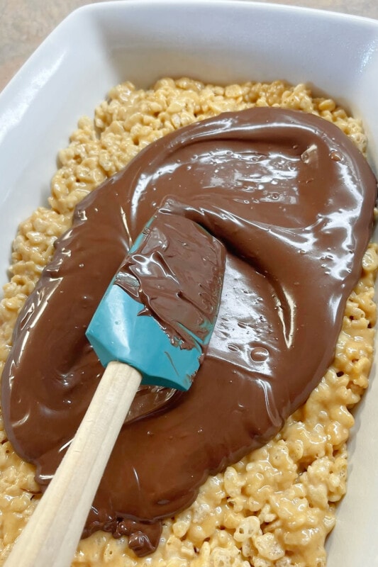 Melted chocolate spread over rice krispie treat mixture. 