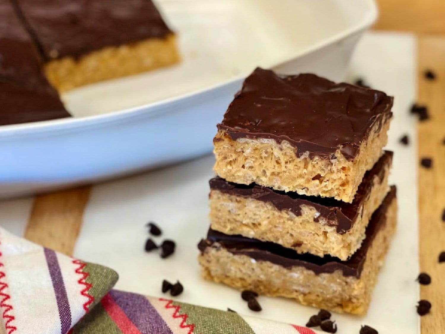 Chocolate-covered rice krispie treats in a stack. 