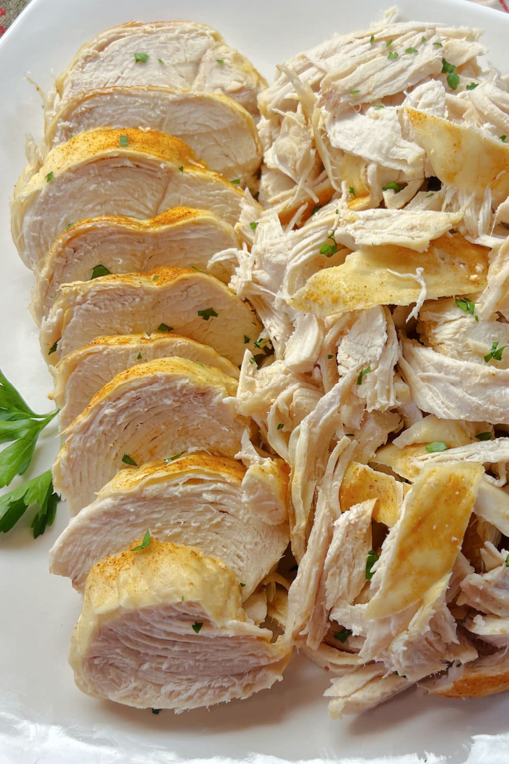 Shredded chicken piled next to sliced chicken breast medallions. 