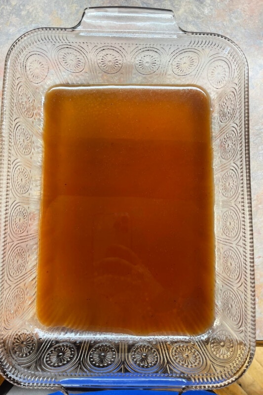 Barbecue sauce spread over the bottom of a 9x13 casserole dish. 