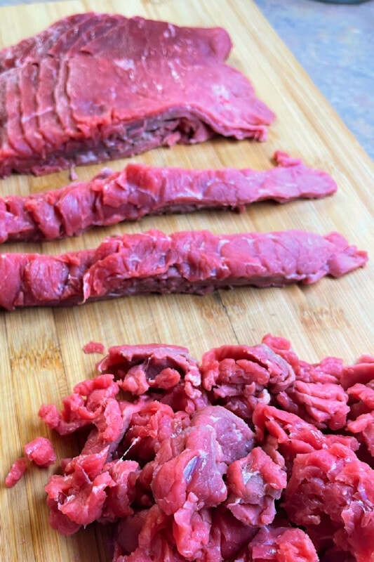 Steak cut into slices and then into pieces. 