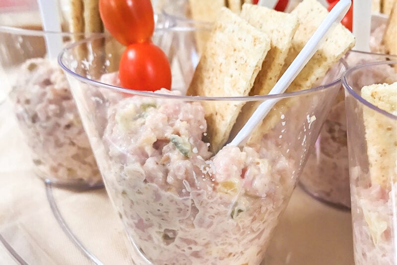 Deviled Ham Spread served in individual cups with cherry tomatoes, crackers and a small sppon.