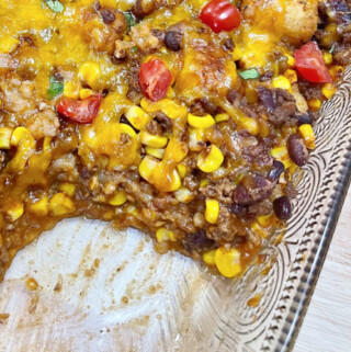 Taco Tater Tot Casserole with a serving removed from the pan.