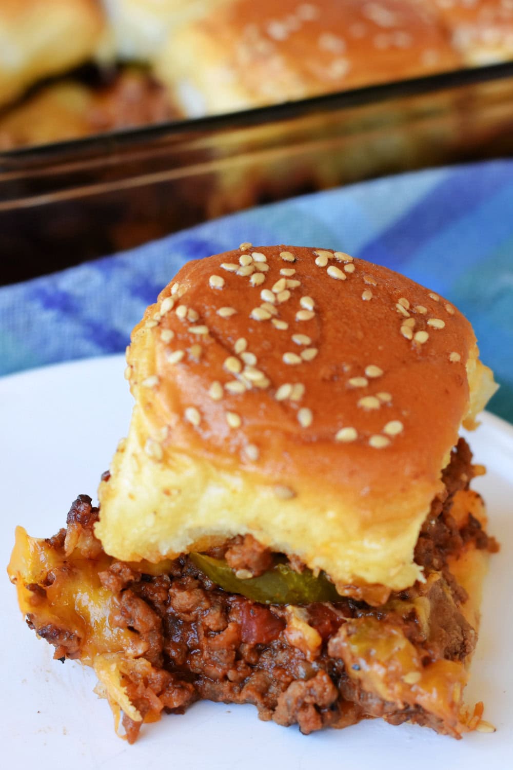 A warm Bacon Cheeseburger Slider on a white plate. 