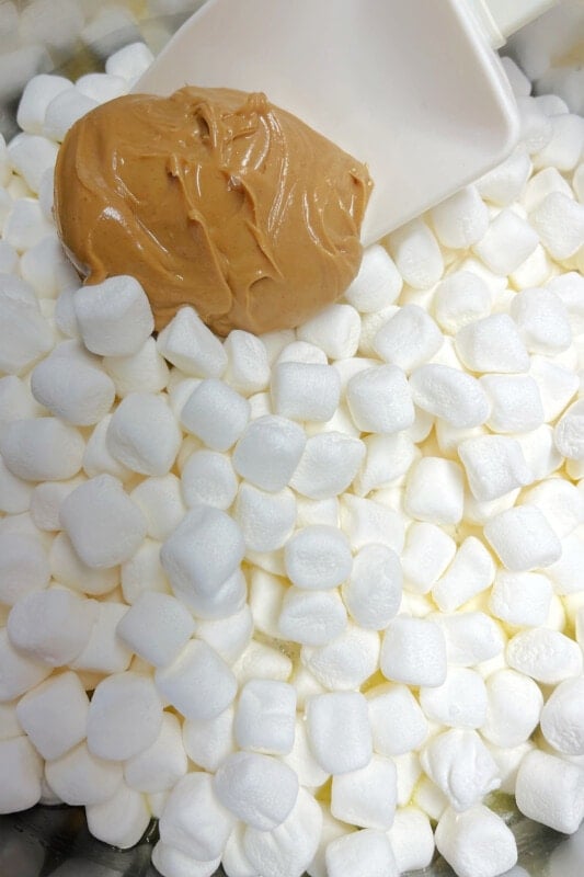 Peanut butter added to marshmallows that are beginning to melt. 