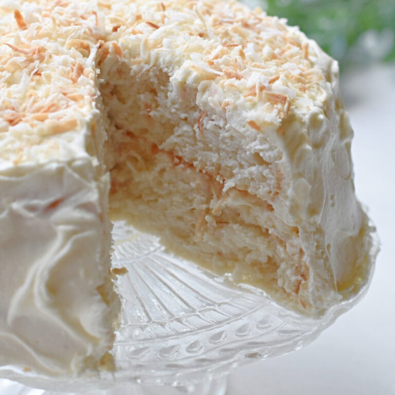 White Box Cake with Coconut milk, frosting and shredded coconut.
