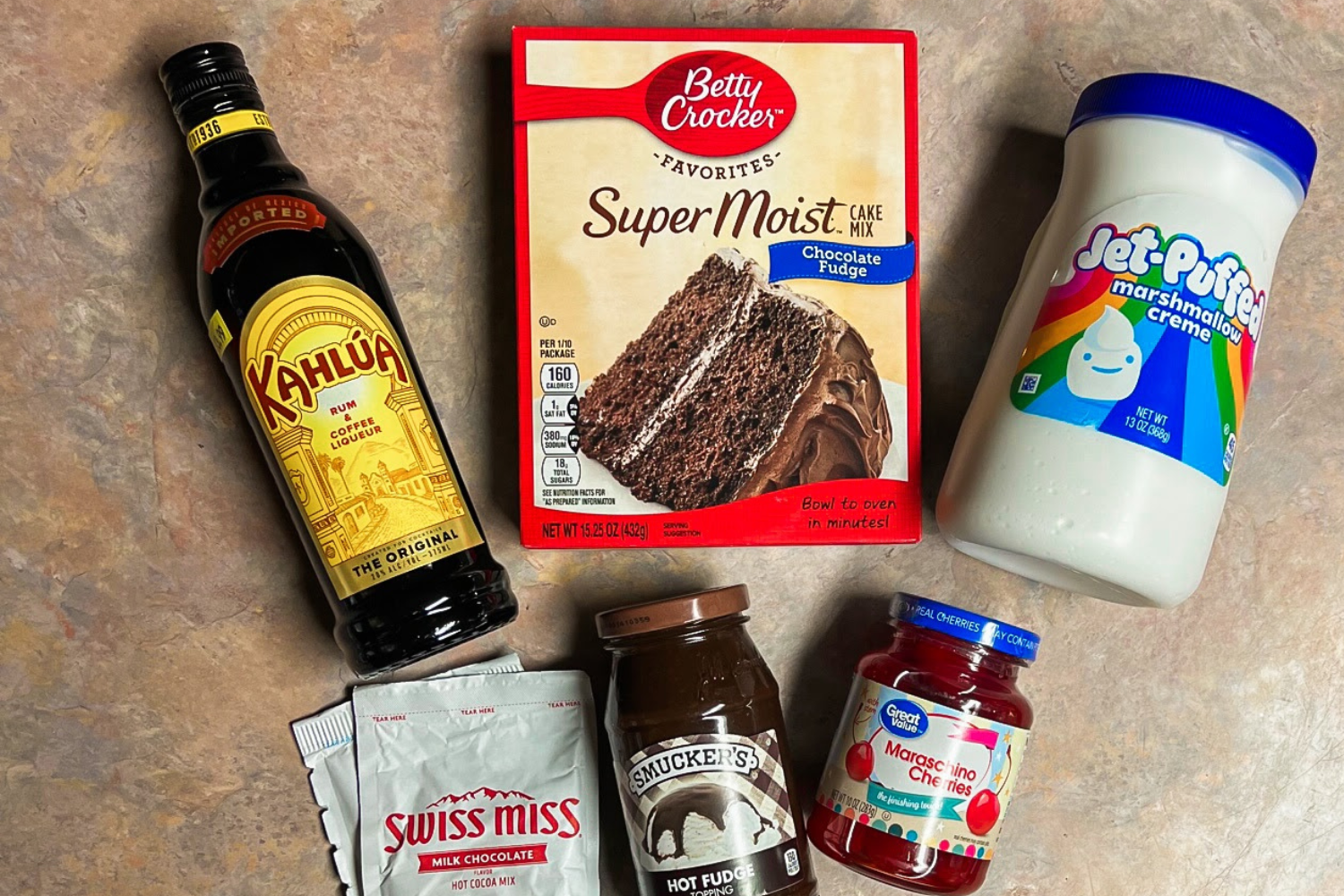 Ingredients for chocolate poke cake with marshmallow creme and hot chocolate.