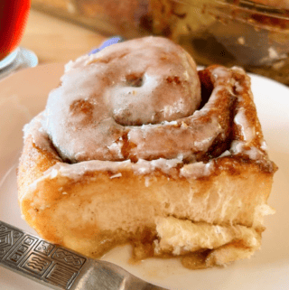 Rhodes frozen cinnamon roll on a plate with afork