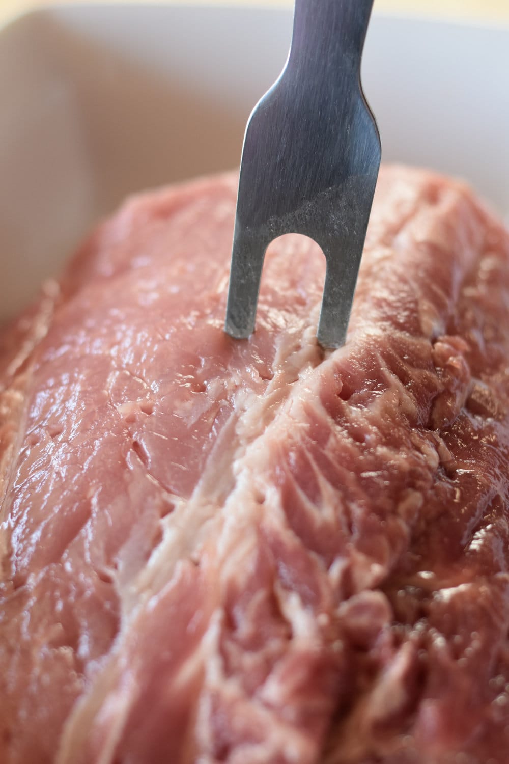 Piercing the ribeye roast with a fork over the surface. 