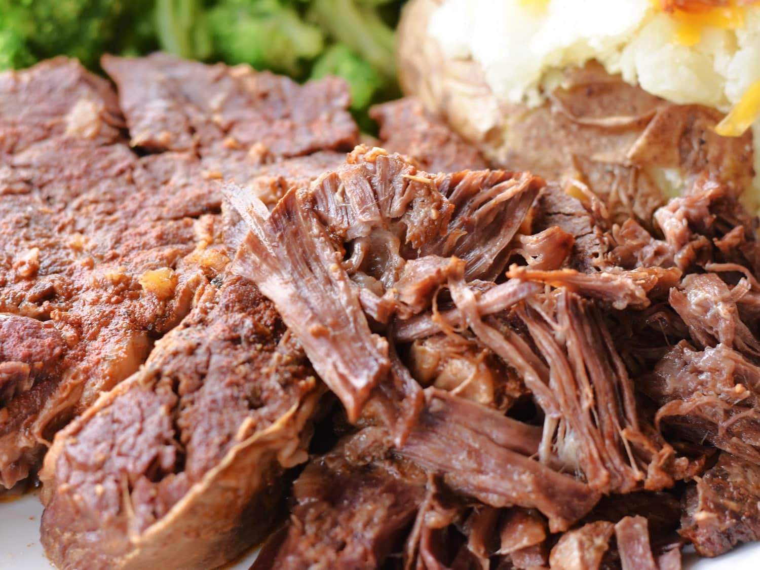 Fully cooked tender roast beef on a platter. 