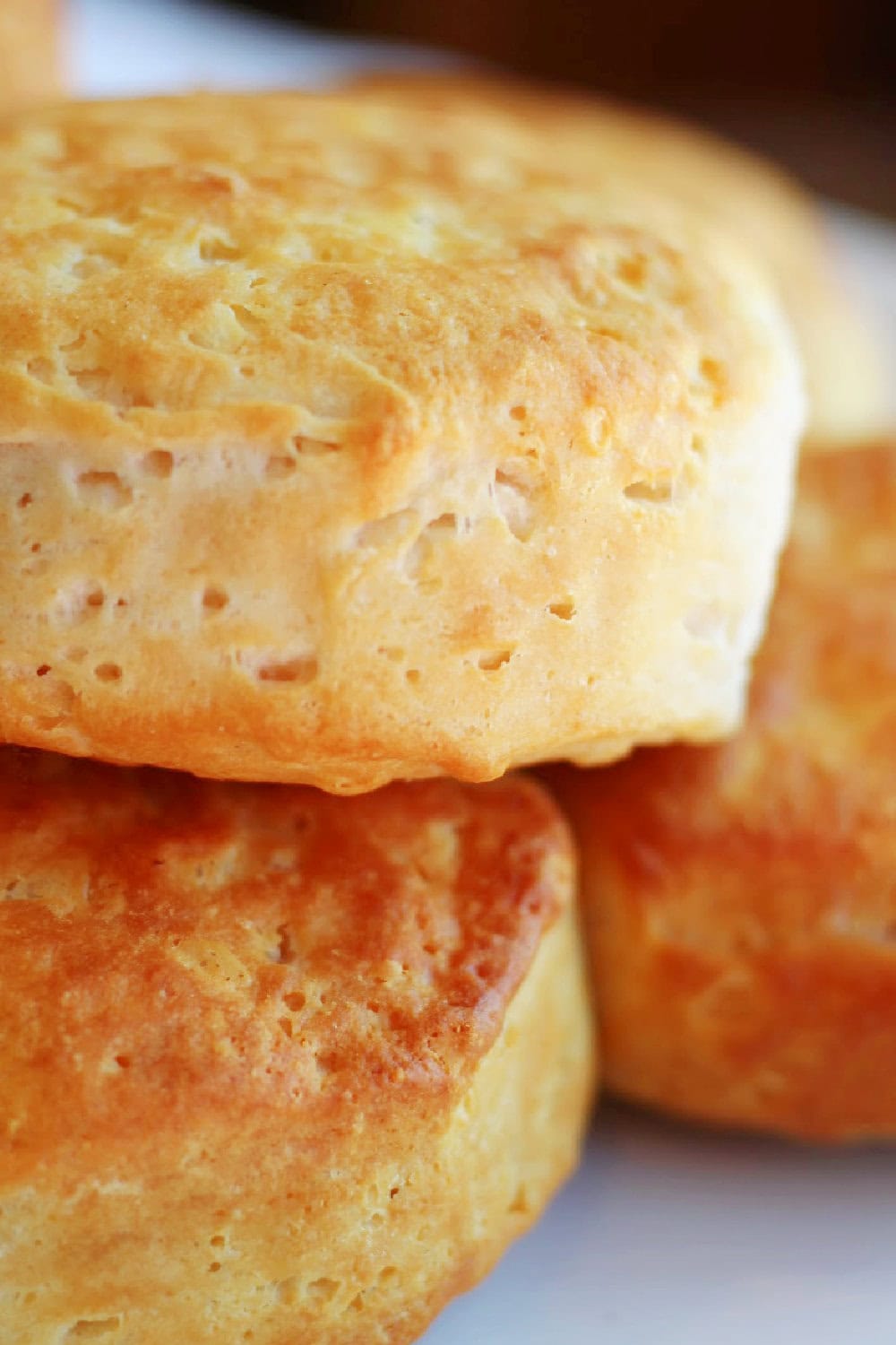 Golden brown, flakey biscuits piled high. 