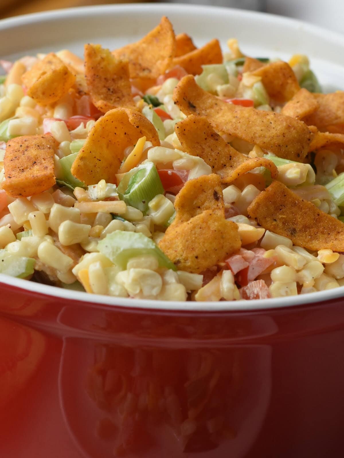 Chili Cheese Fritos on top of a freshly made corn salad. 