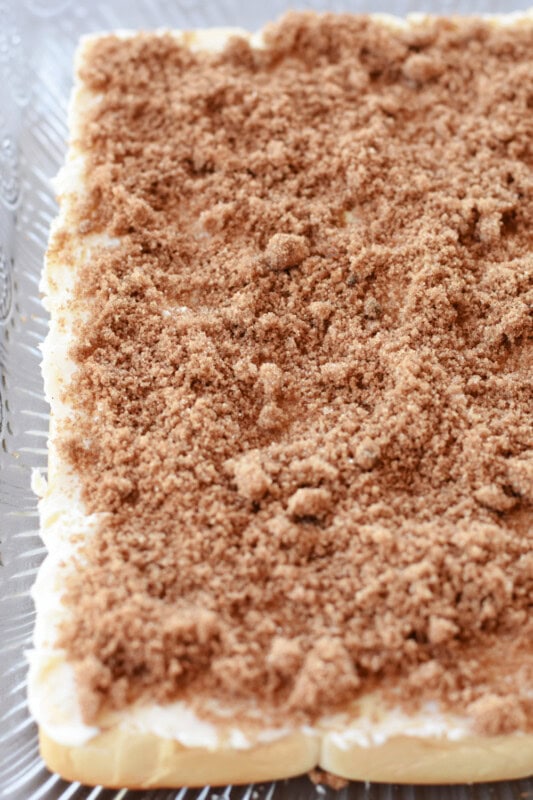 Brown sugar cinnamon mixture sprinkled over the bottom Hawaiian rolls.