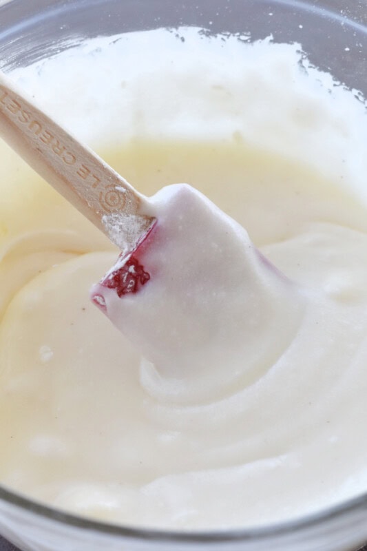 Smooth and creamy cinnamon roll frosting in a bowl. 