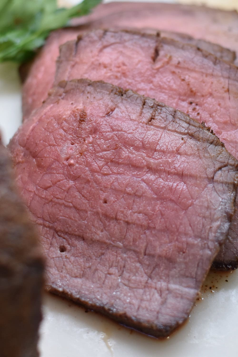 Slices of medium rare top round roast. 