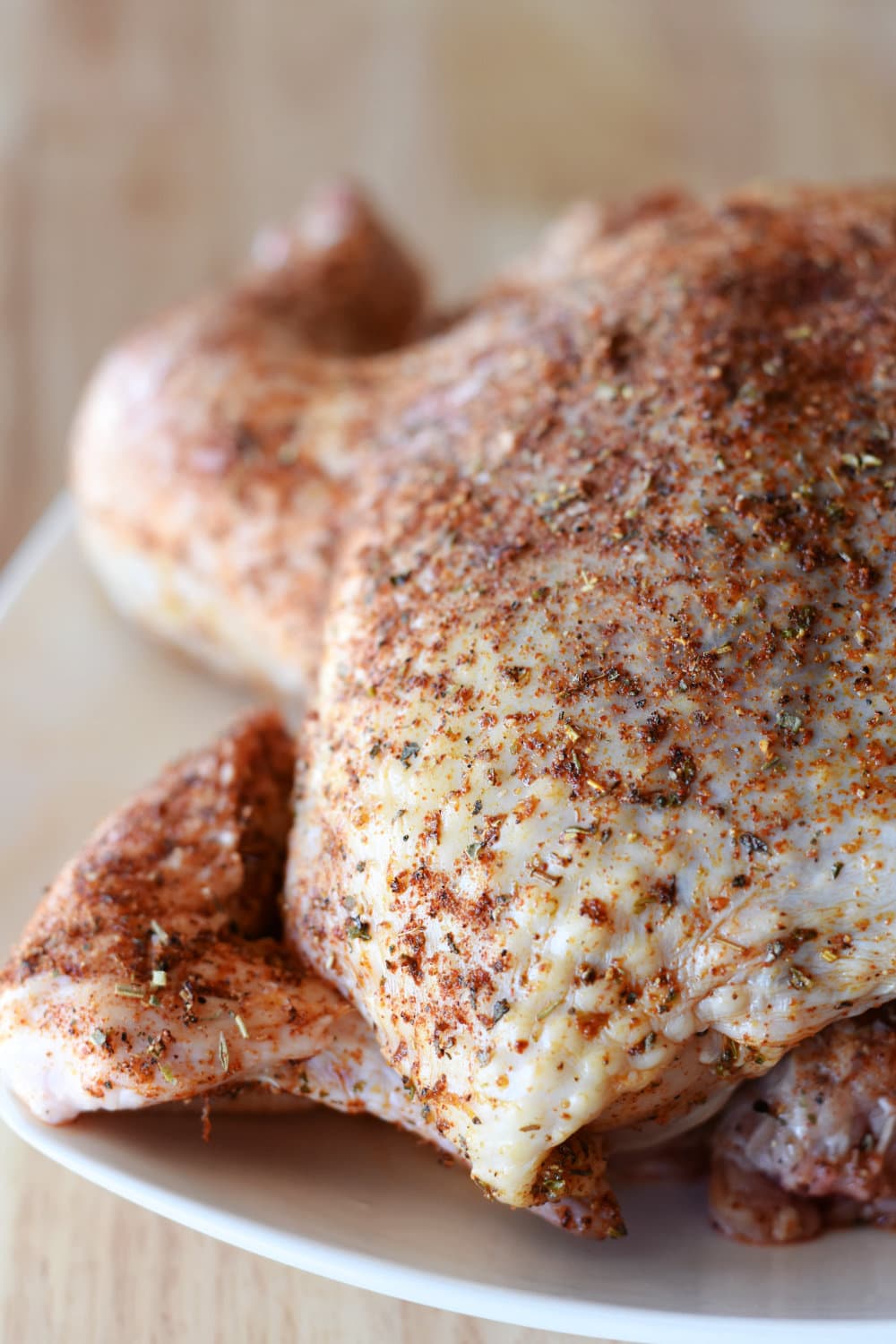 A freshly seasoned chicken ready for the air fryer. 