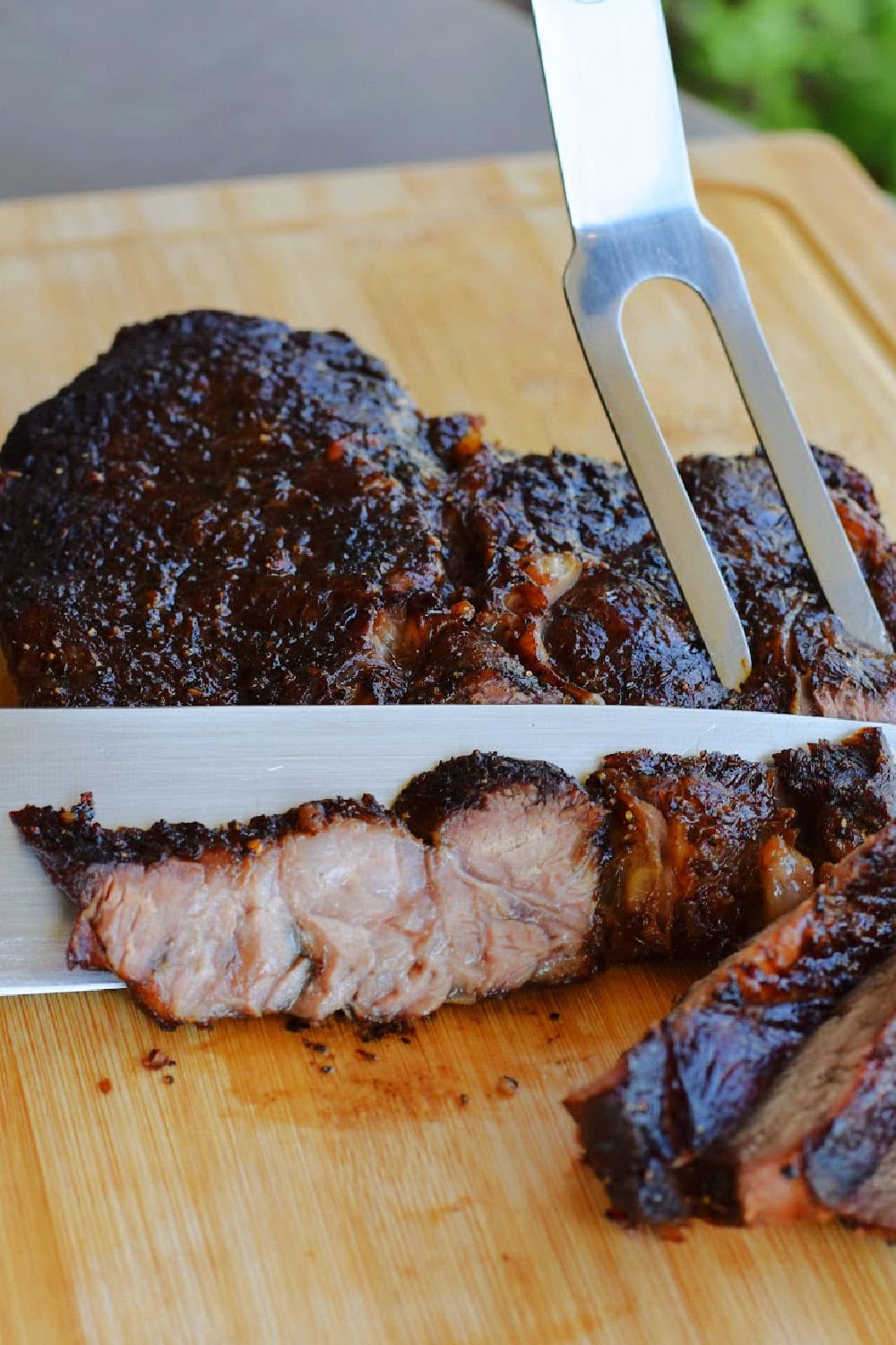 Slicing the air fryer chuck roast on a cutting board. 