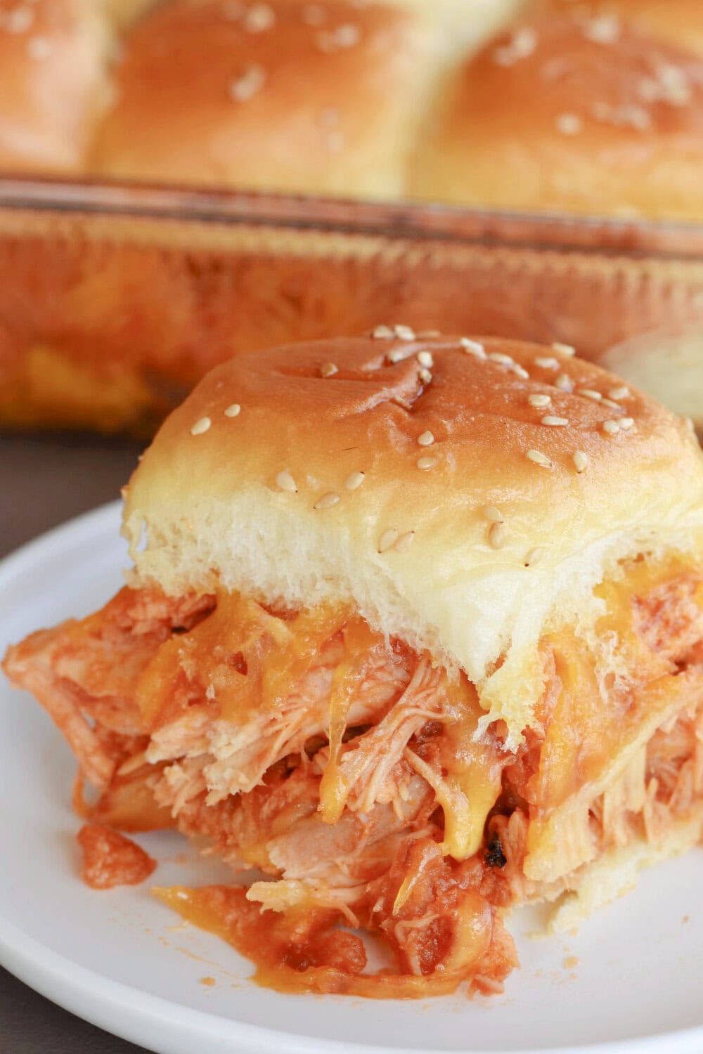 A fat and juicy BBQ Chicken Slider on a white plate. 