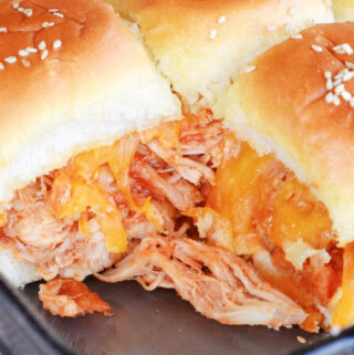 BBQ Chicken Sliders with lots of sauce and melted cheddar cheese.