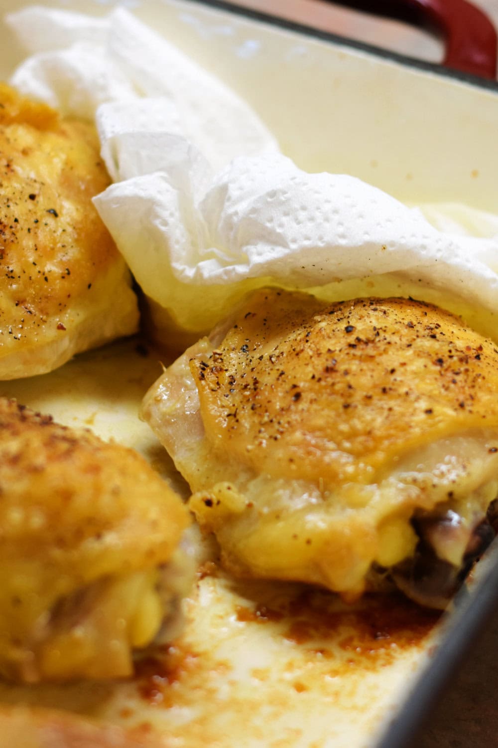 Paper towels soaking up the chicken fats in the baking pan. 