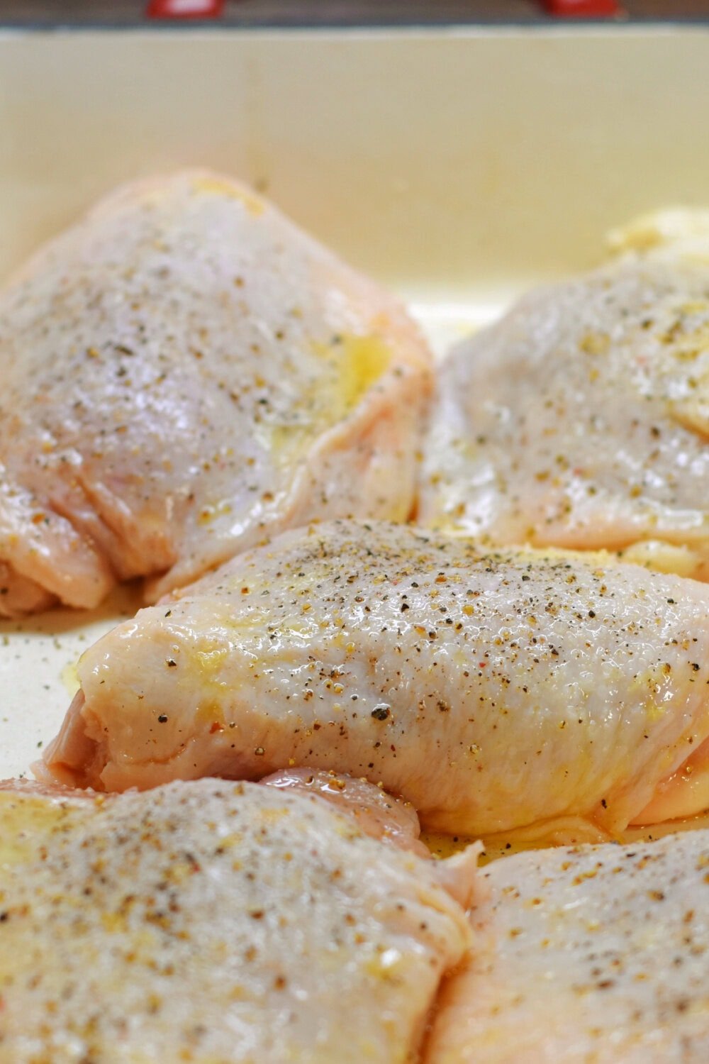 Bone-in, skin-on chicken thighs brushed with oil and seasoned. 