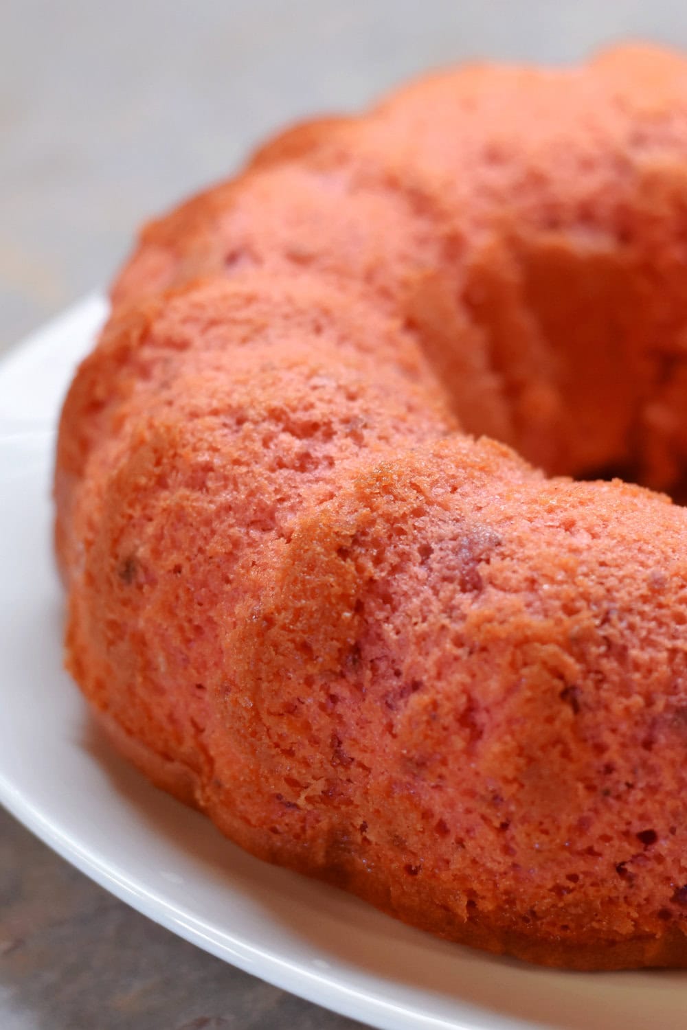 A cooled strawberry pound cake that has been removed from the Bundt pan. 