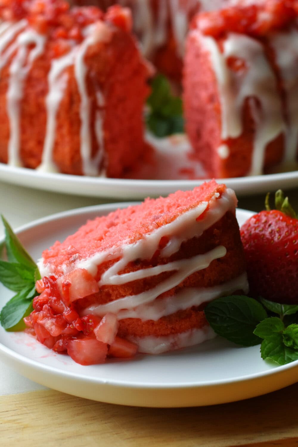 A fat slice of Strawberry Pound Cake on a white plate. 