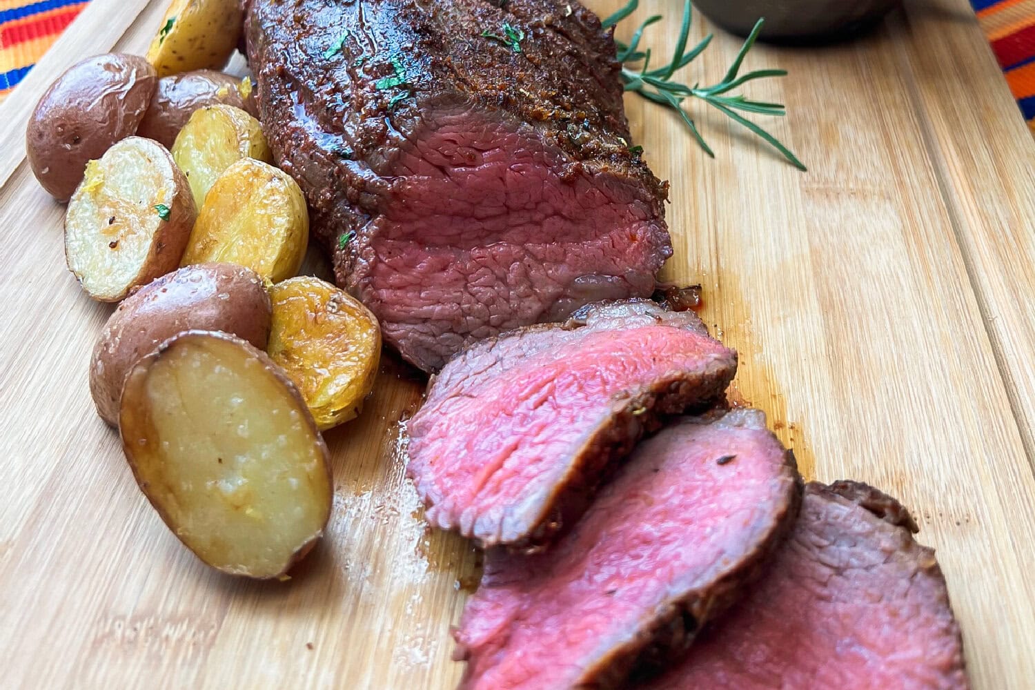 A whole beef tri tip roast with crispy potatoes. 