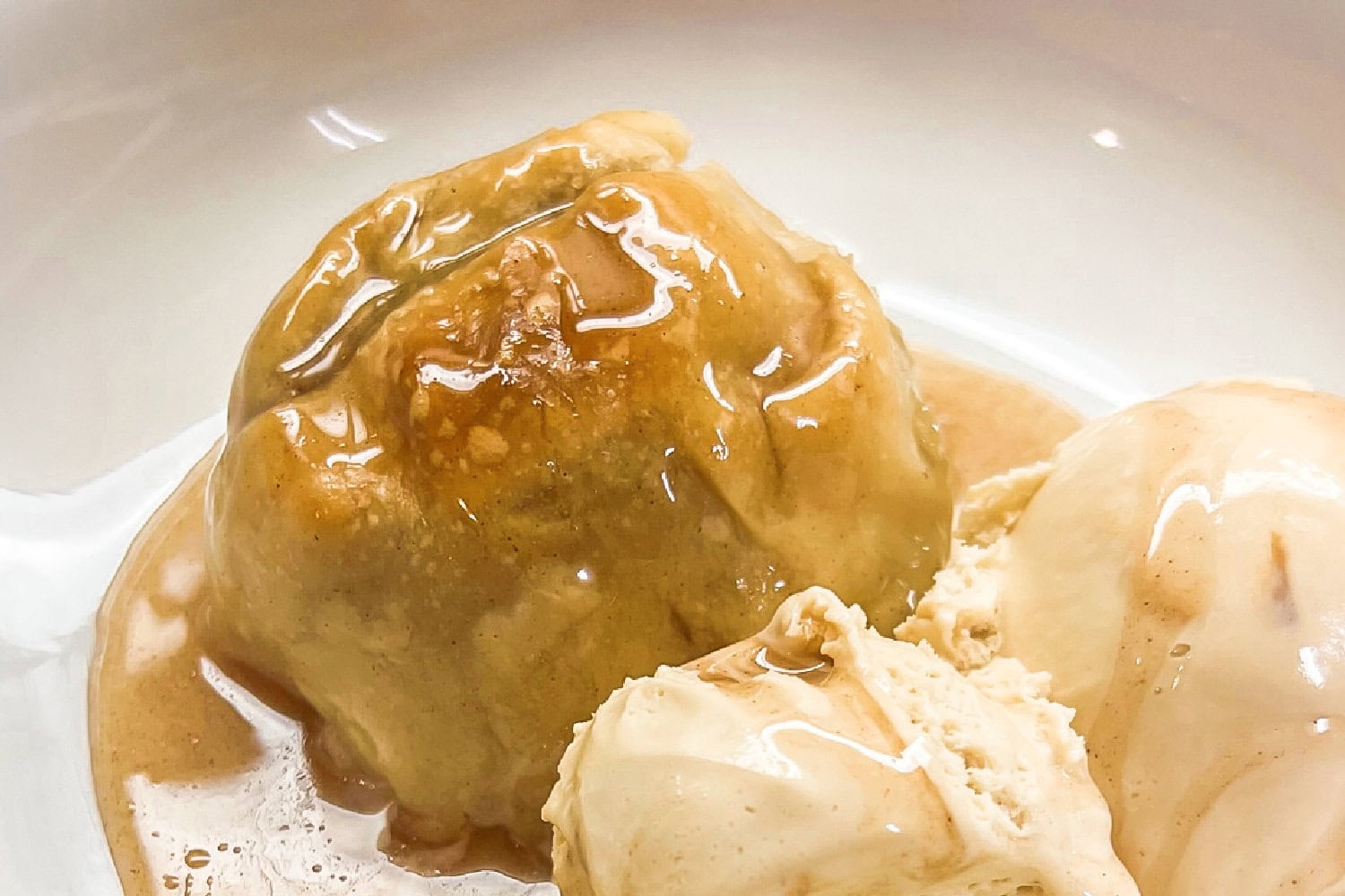 Old fashioned apple dumplings with ice cream. 