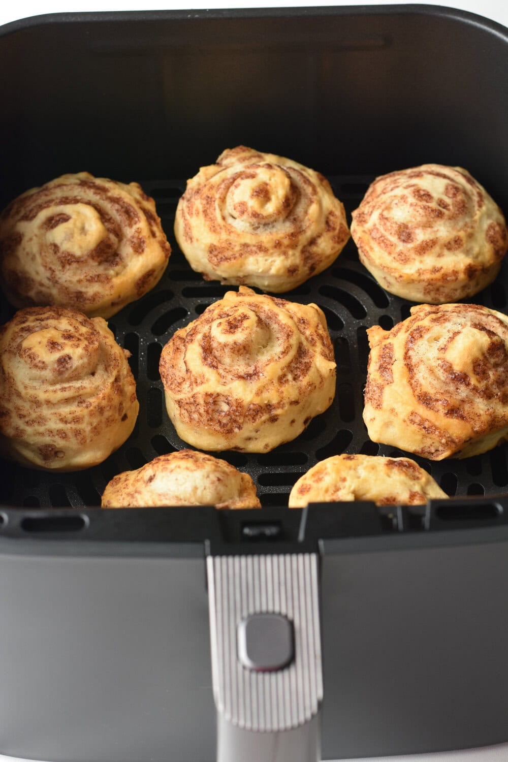 Perfectly cooked pillsbury cinnamon rolls made in the air fryer. 