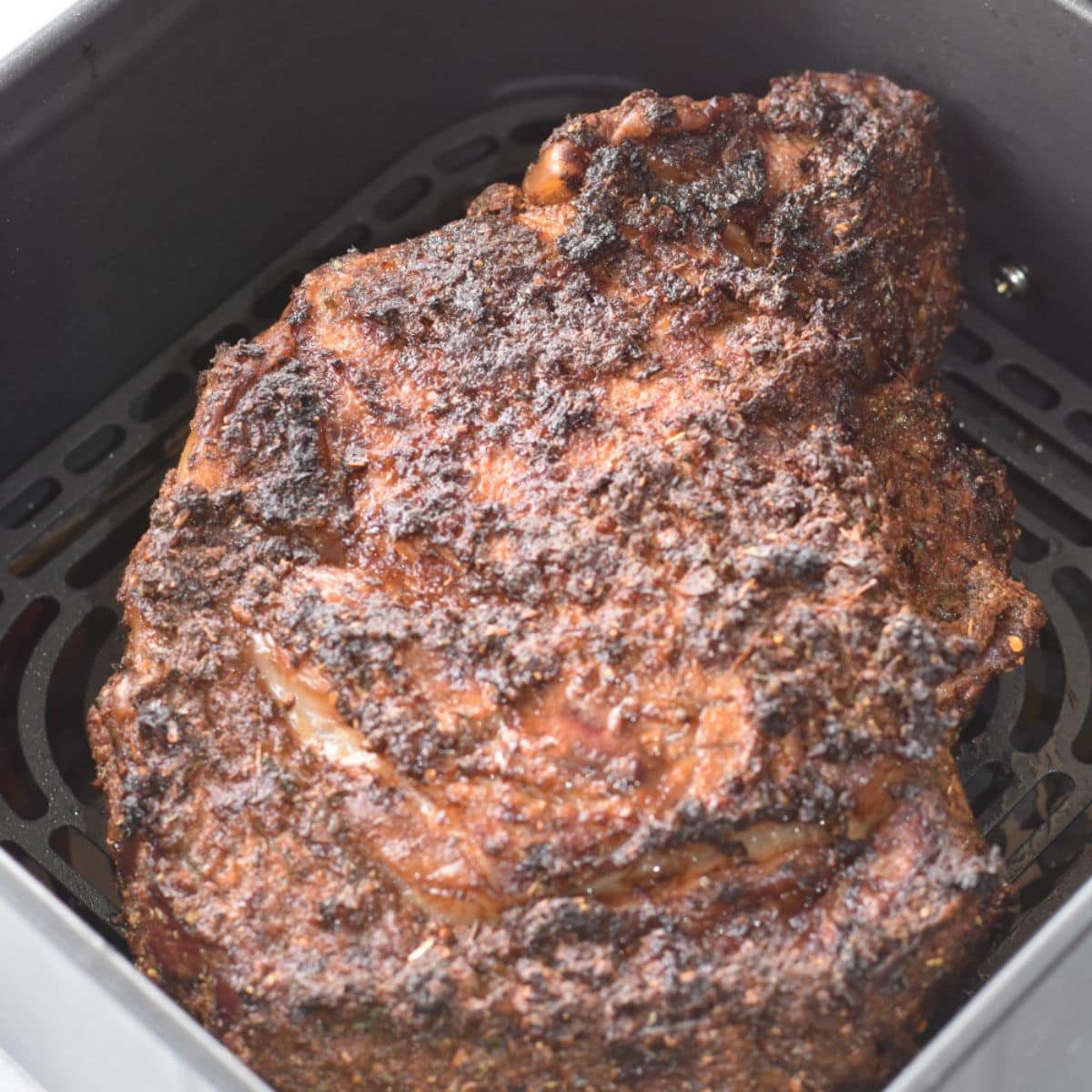 Quick and easy air fryer prime rib in an air fryer basket.