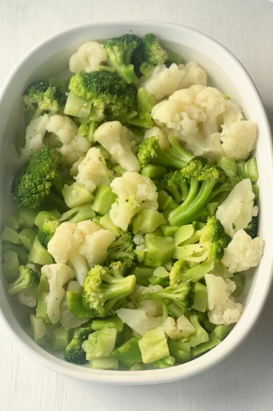 Vegetables placed into a casserole dish. 