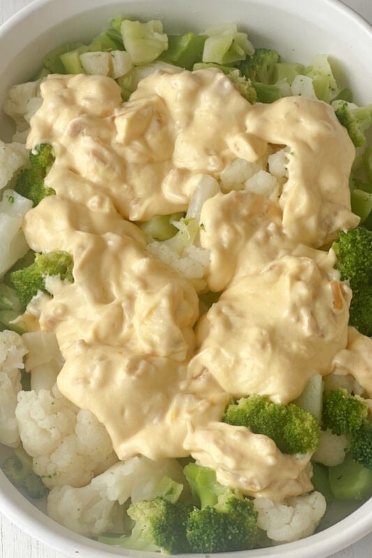 Cheese sauce placed on top of the vegetables. 