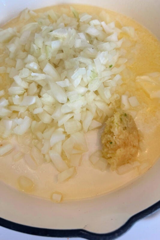 Diced onions in butter with garlic in a skillet. 