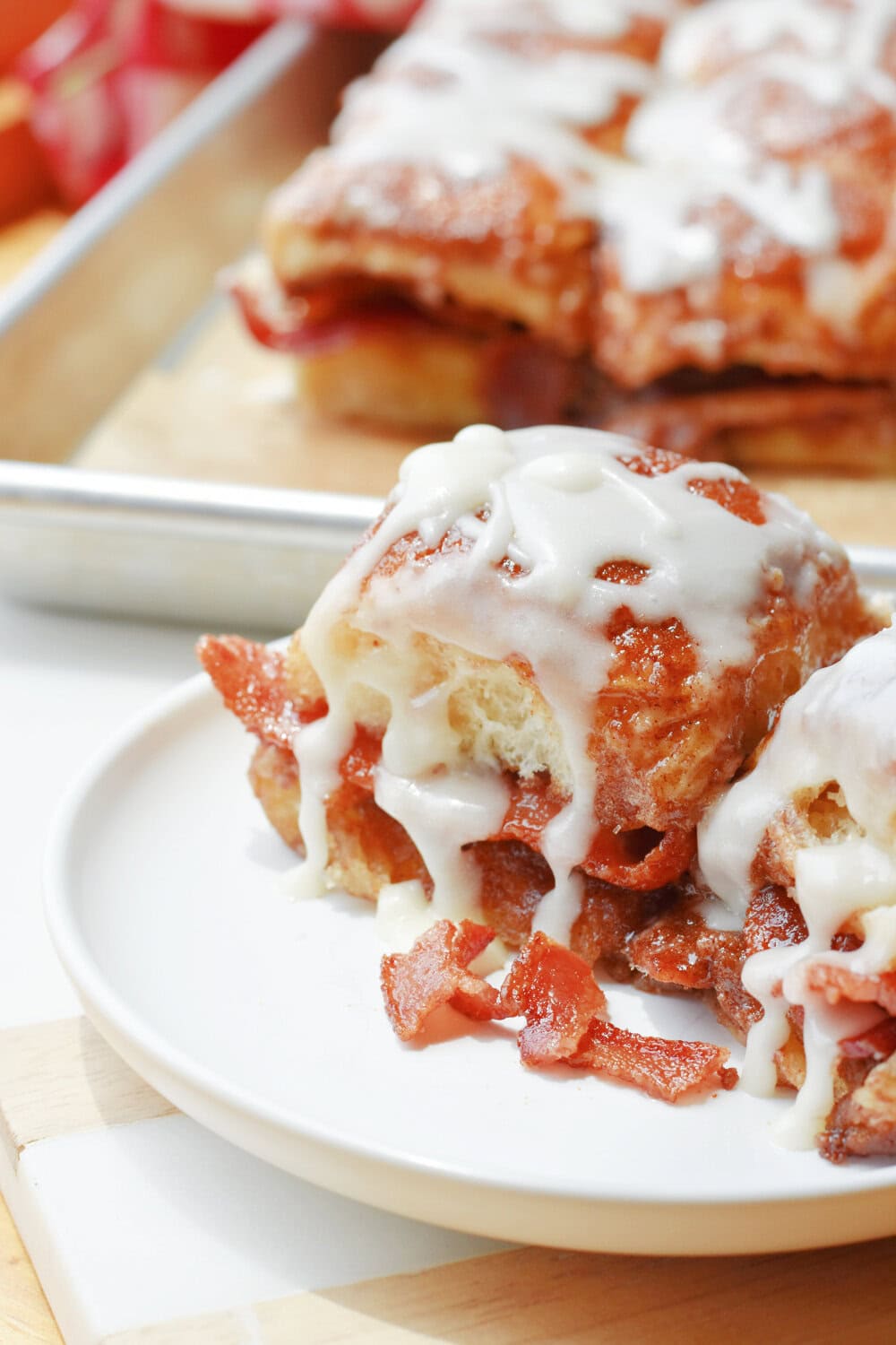 Glazed Bacon-Stuffed Cinnamon Rolls with bacon crumbles. 