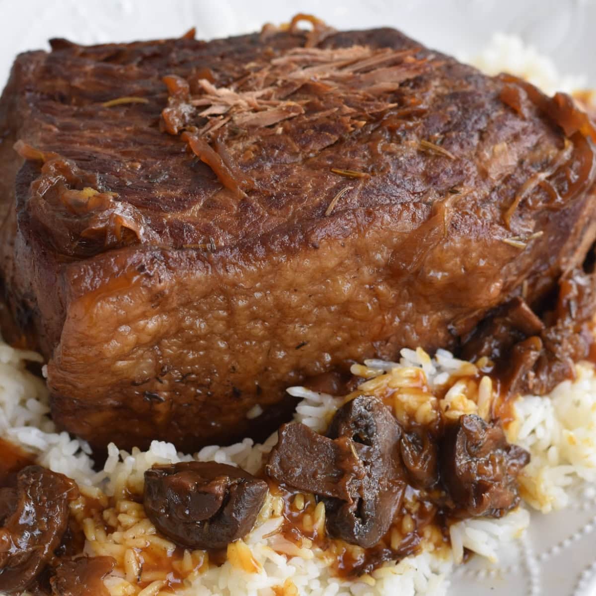 Quick and easy pressure cooker bottom round roast with rice and gravy.