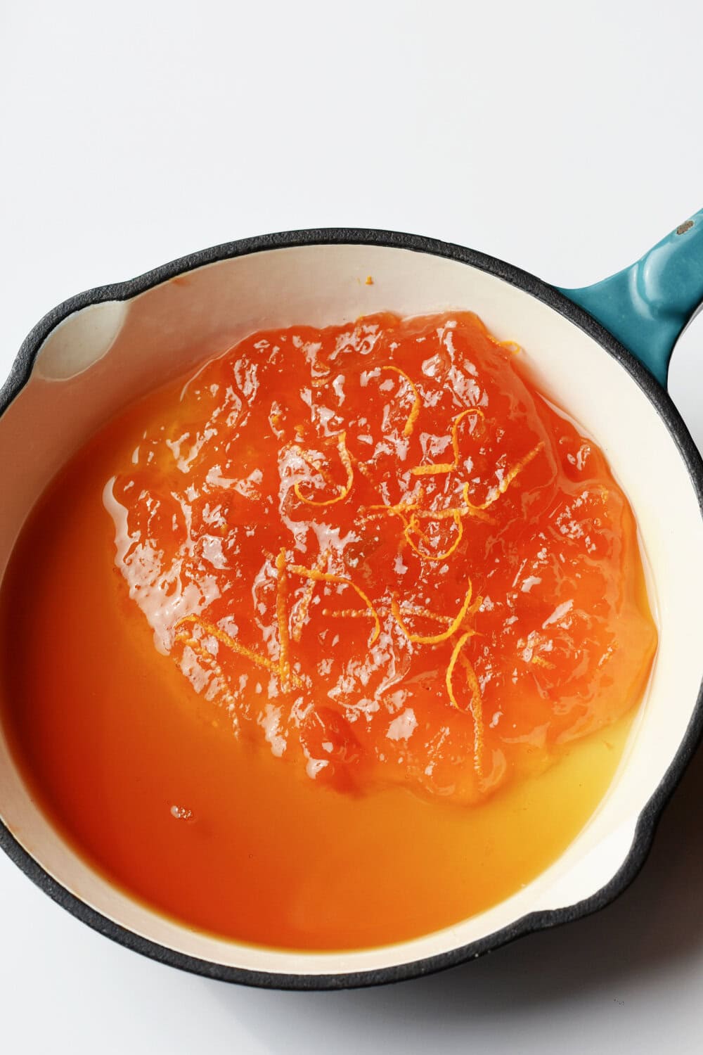 marmalade-maple-syrup Pure maple syrup and orange marmalade in a small skillet.