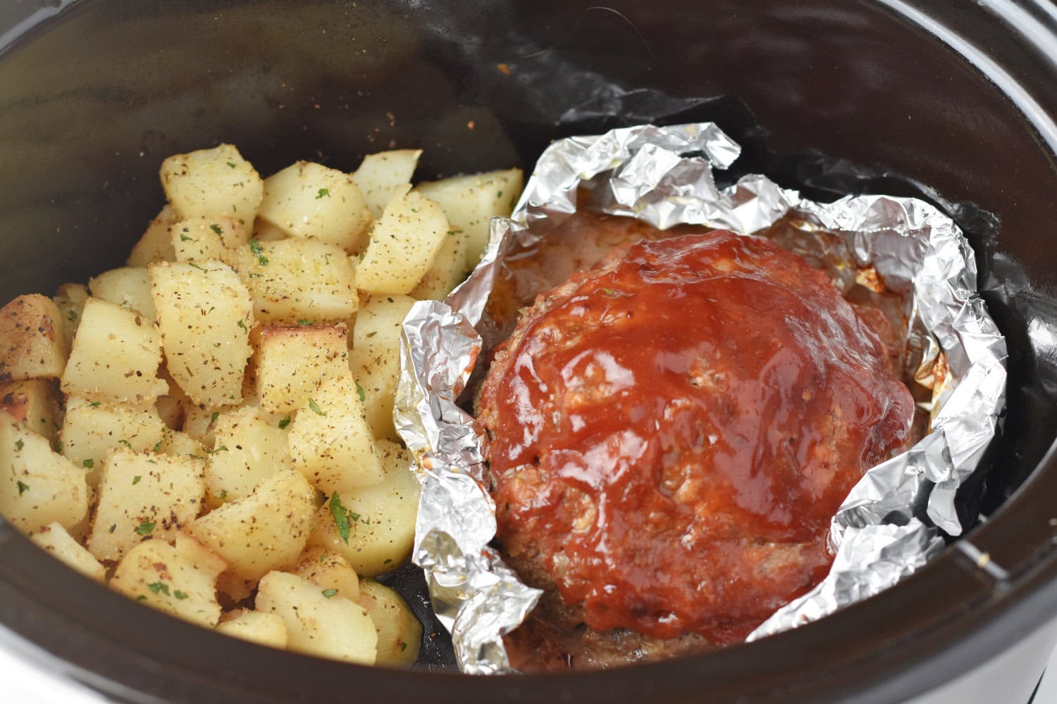 Easy slow cooker meatloaf made with diced potatoes. 