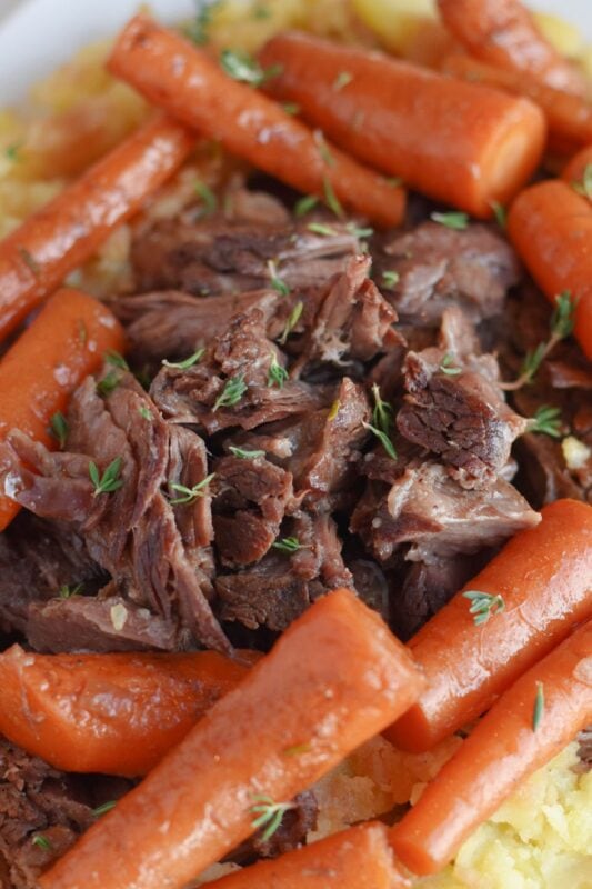 Shredded braised chuck roast with carrots and potatoes.