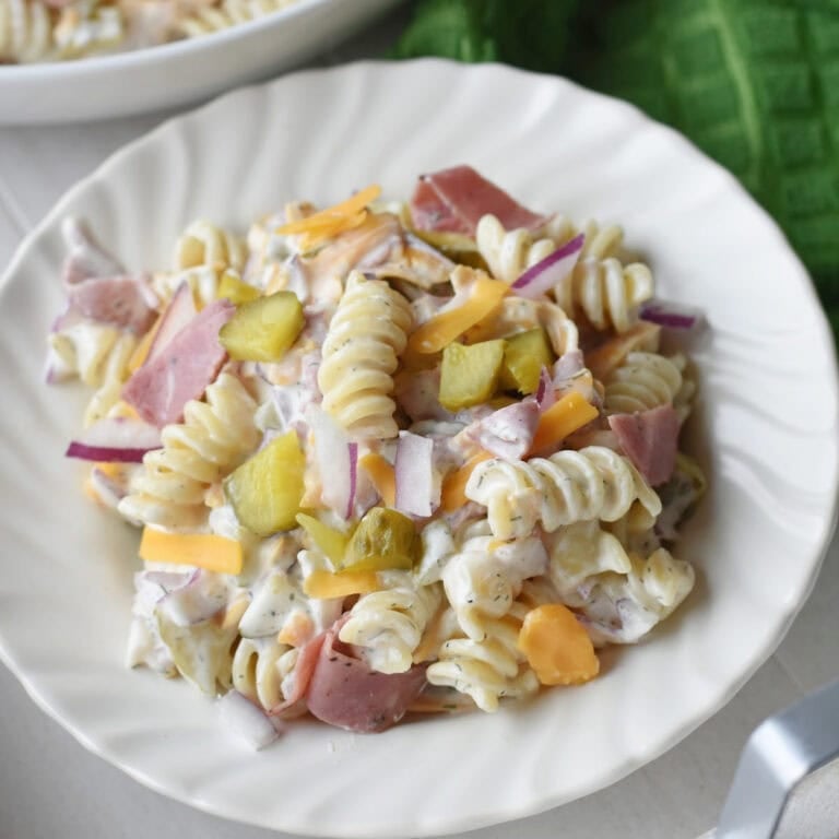 Pasta salad with dill pickles in a creamy sauce.