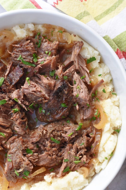 Beef pot roast made with an arm roast with mashed potatoes.