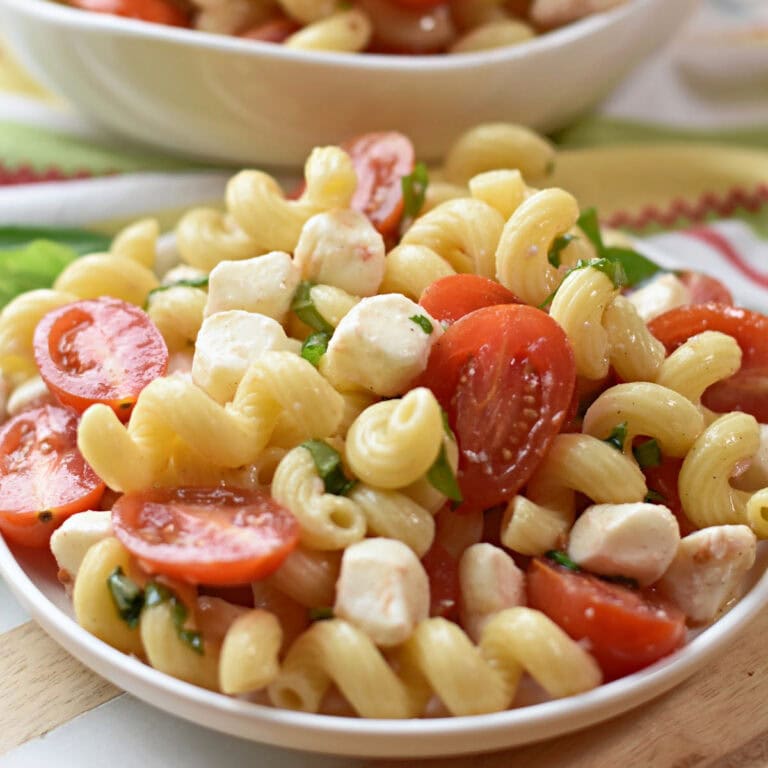 A serving of Italian Caprese Pasta Salad made with Cellentani noodles.