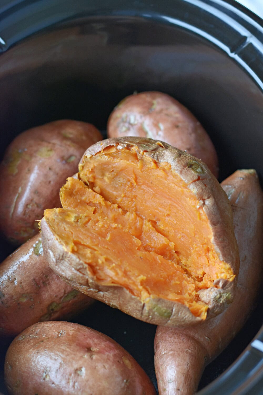 sliced-sweet-potato-slow-cooker Sliced tender and juicy sweet potato in a slow cooker.