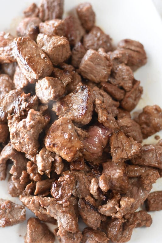 browned-beef-tips-plate Browned meat reserved on a plate.