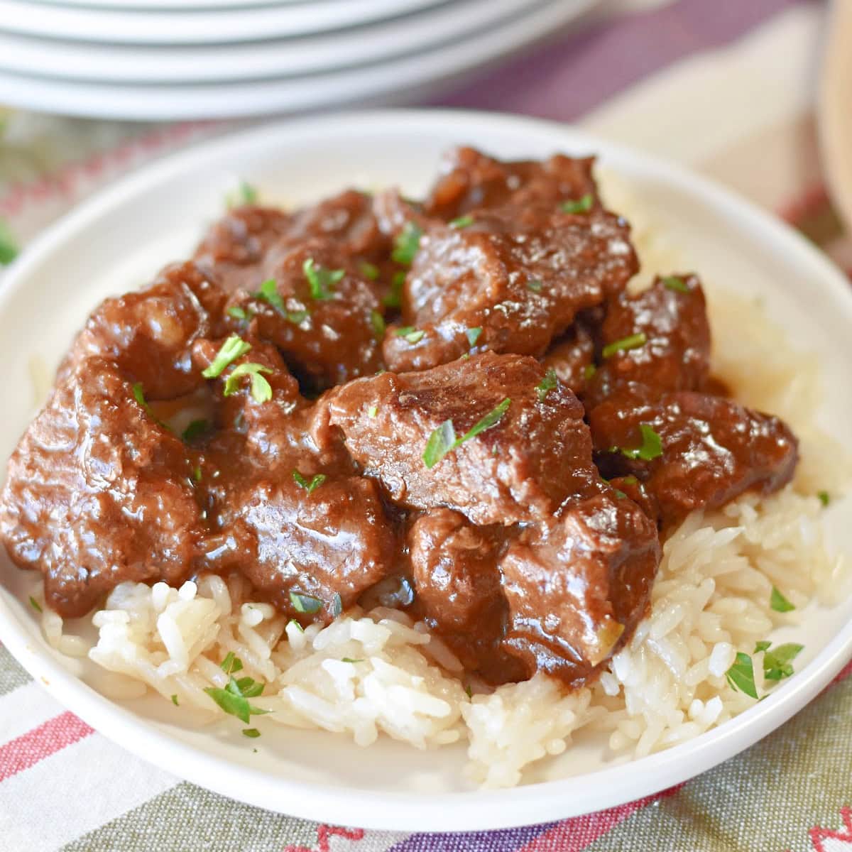 Chunks of stew meat served with dark brown gravy.