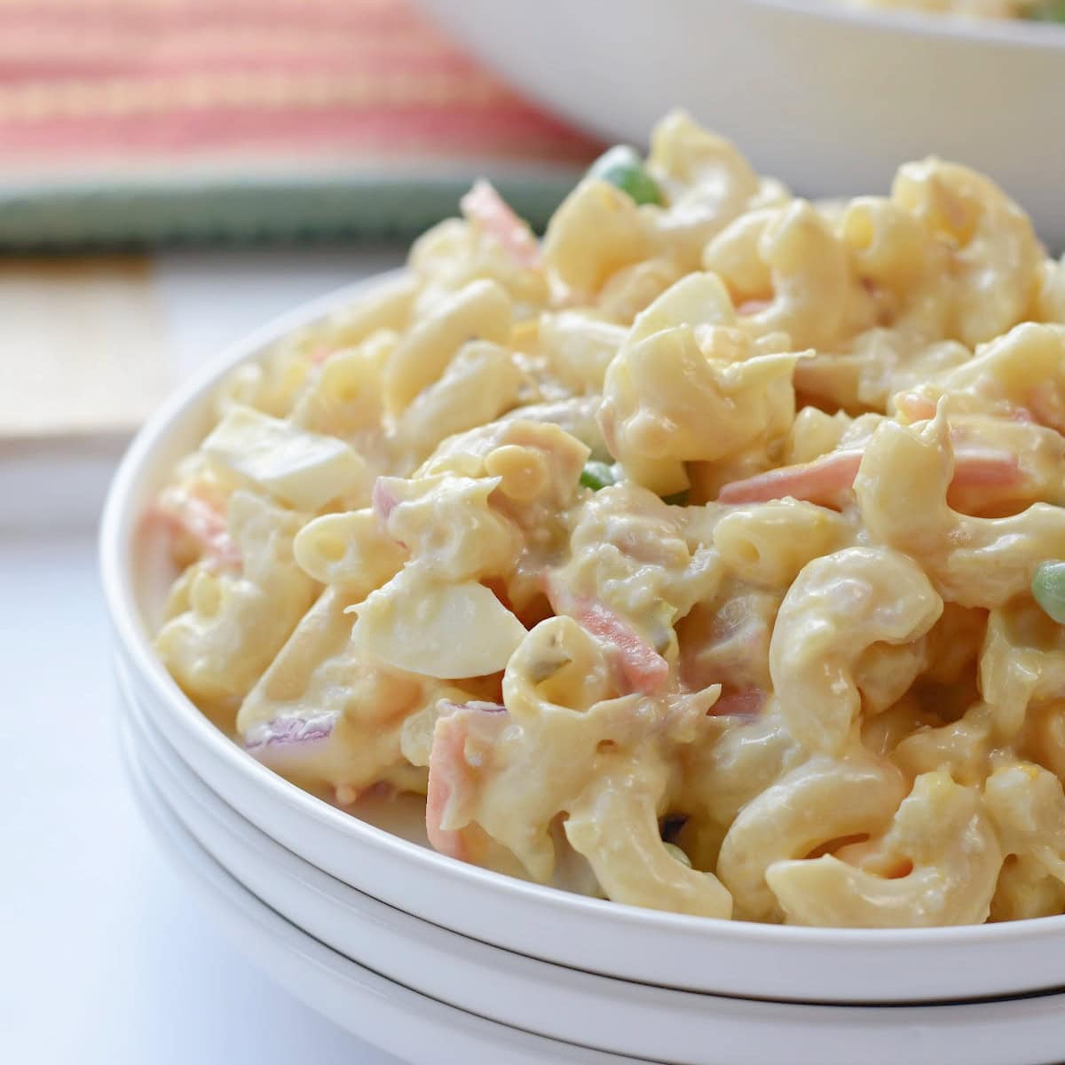 A plate of chicken macaroni pasta salad made with sweetened condensed milk.