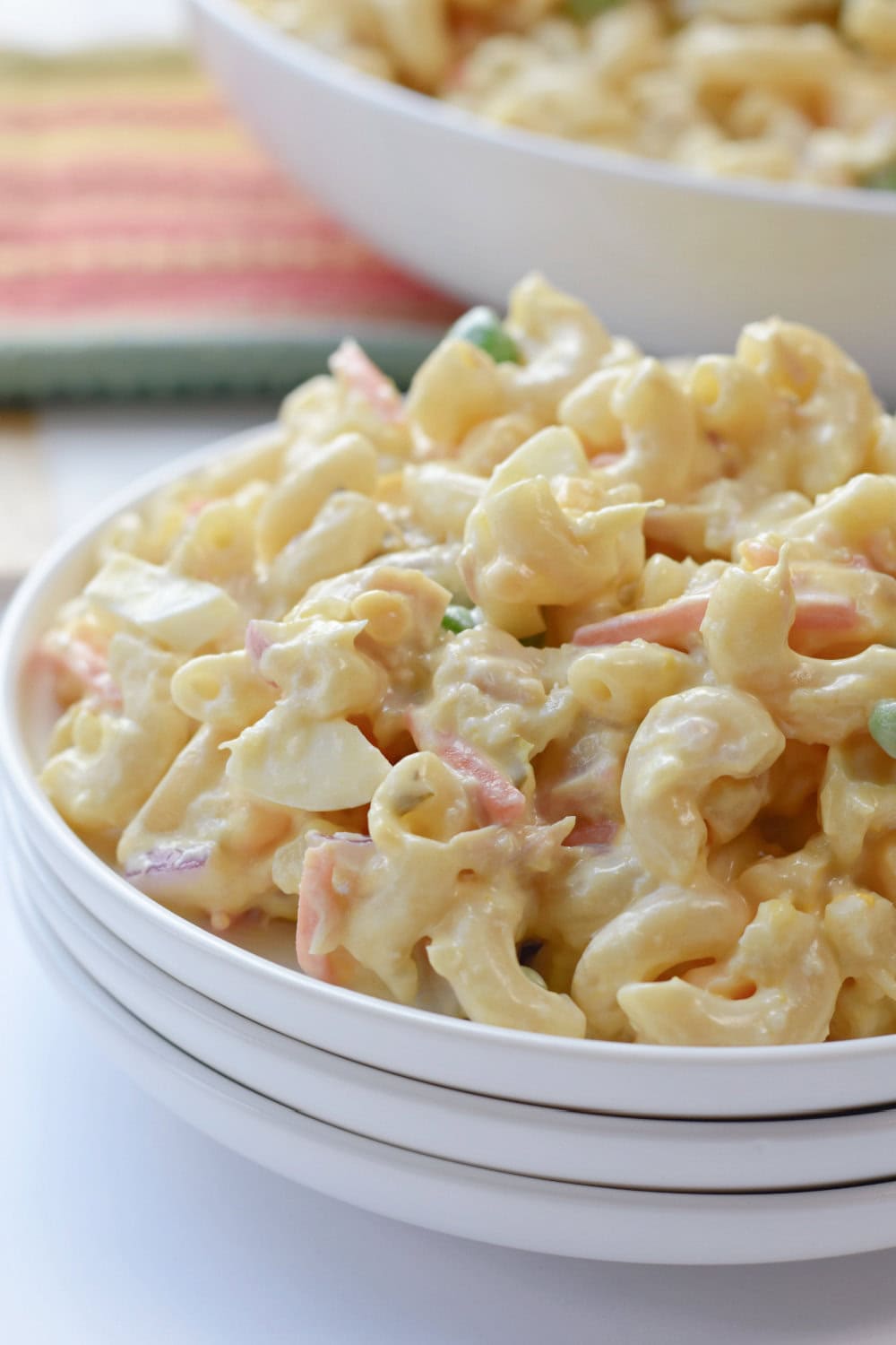 chicken-macaroni-salad-creamy Chicken macaroni pasta salad on a white serving plate.