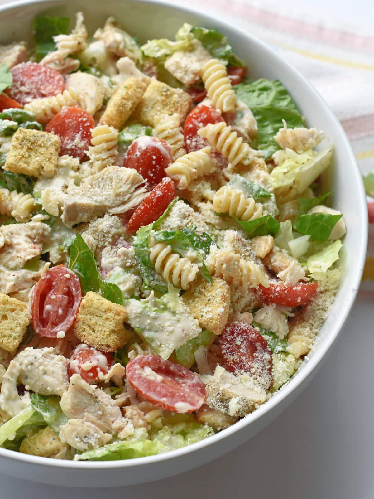 caesar-pasta-salad-serving Caesar Pasta Salad made with shredded chicken in a serving bowl.